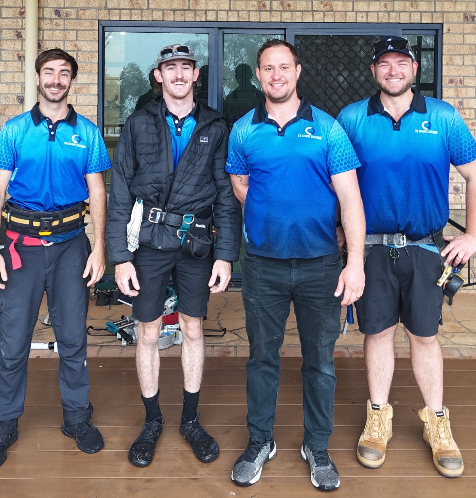 The CQ Smart Screens team in branded blue polo shirts